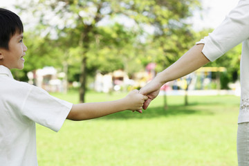 Mother and son holding hands