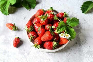 Wall Mural - Fresh strawberries in a bowl on a gray background, still life