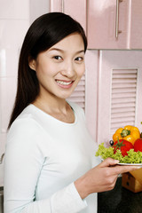 Woman with a plate of vegetables