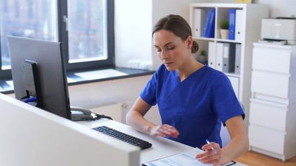medicine, technology and healthcare concept - female doctor or nurse with computer and medical repor