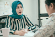 © PR Image Factory - group of young asian muslim and chinese women having business meeting and signing contract in office. recruitment and agreement concept. elegant islam lady worker talking and explaining about project