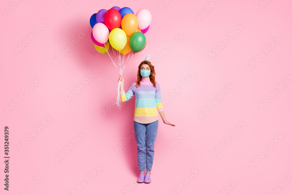 Full length photo of pretty lady quarantine arrange birthday party best friend hold many air balloons unexpected surprise wear face mask sweater jeans shoes isolated pink color background - obrazy, fototapety, plakaty 