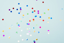 Confetti Scattered On The Light Blue Background. Bright Dots On The Background.