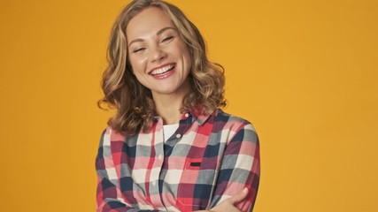 Sticker - Young smiling girl isolated over yellow wall background