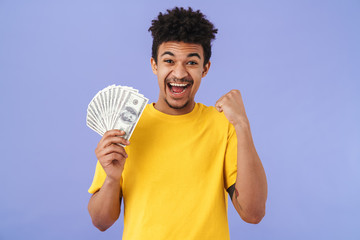 Poster - Photo of african american man holding dollars and making winner gesture