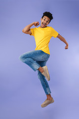 Poster - Photo of joyful african american man jumping and making fun at camera