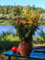 Wall Mural - Bouquet of delicate field's flowers on the water background