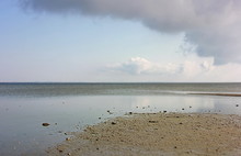 Seascape, Sea Of Azov After A Storm, Low Tide, Water Surface Against The Background Of Outgoing Clouds And Clouds