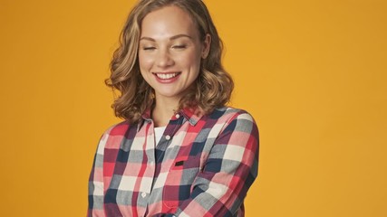 Wall Mural - Young happy optimistic girl isolated over yellow wall background