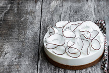 Homemade Cheesecake Decorated With Fresh Coconut Flakes On Rustic Wooden Table