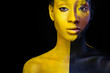 © Mike Orlov - Woman with black body paint. Cheerful young african girl with art bodypaint. An amazing model with yellow makeup. Closeup face.