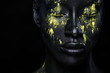 © Mike Orlov - Woman with black body paint. Cheerful young african girl with art bodypaint. An amazing model with yellow makeup. Closeup face.