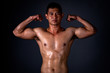 © ritfuse - A strong Asian man raised his arms to show his strong and beautiful muscles from exercise