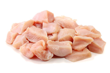 pile of fresh diced and sliced raw chicken breast, cube form, isolated on white background