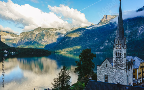 Sunset on Hallstatt village in Alps with beautiful lake reflections , Hallstatt is beautiful village located Alps at the Hallstatter lake and promoted by UNESCO World Heritage region. © sherkeen