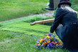 woman with wreath at graveside
