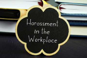 Harassment in the Workplace is shown on the conceptual business photo