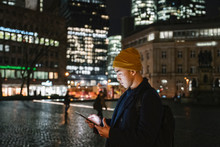 Man Using Tablet In The City At Night