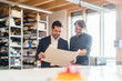© Westend61 - Smiling businessman and employee discussing plan in factory