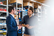 © Westend61 - Businessman and employee talking in factory