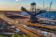High Angle View Of Bucket-wheel Excavator At Mine Against Sky During Sunset