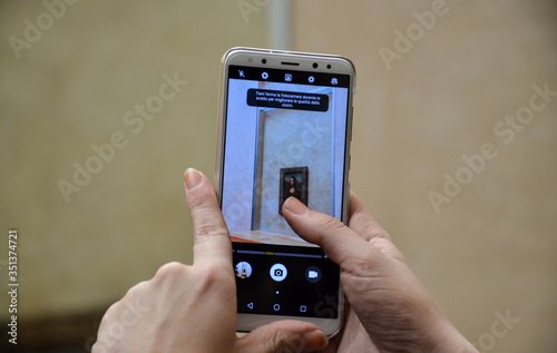 Cuadros en Lienzo Manos tomando foto a La Gioconda