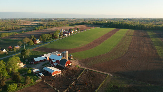 aerial view of american countryside landscape. farm, red barn, cows. rural scenery, farmland. sunny 
