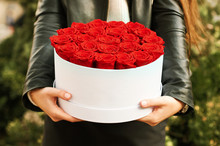 Young Girl Holding Red Roses In White Gift Box