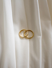 Close-up Of Wedding Rings On Fabric