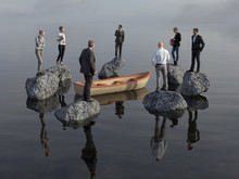 Group Of People Stands On Stones In The Sea