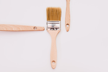 Simple background with new wooden paintbrushes isolated on white studio background.