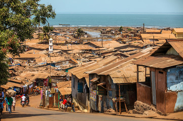 flimsy shacks with corrugated tin roofs make up a township near the coast of freetown, sierra leone,