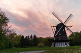 Fototapeta Natura - Windmill with a gorgeous sunset and amazing red and yellow colors in the background. Location is south Sweden.