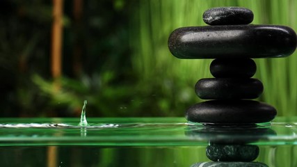 Wall Mural - Water dripping into lake with stack of zen stones in oriental garden