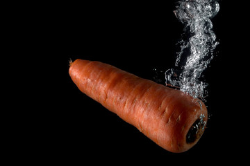 carrot entering the water and splashing