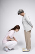 © ImageHit - Senior woman on scale while woman is checking her weight
