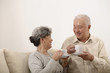 © ImageHit - Senior man and woman enjoying tea