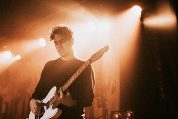 Guitarist playing an electric guitar in a concert