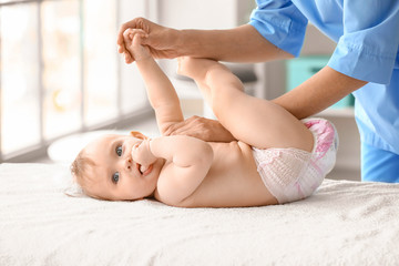 Sticker - Massage therapist working with cute baby in medical center