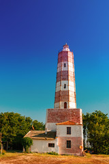 Wall Mural - lighthouse on the beach at sunrise