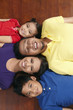 © ImageHit - Family lying on the floor, smiling
