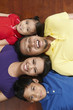 © ImageHit - Family lying on the floor, smiling