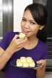 © ImageHit - Woman enjoying a plate of cookies