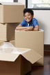© ImageHit - Boy resting his arms on cardboard box