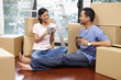 © ImageHit - Man and woman drinking coffee with cardboard boxes around