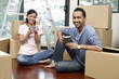 © ImageHit - Man and woman drinking coffee with cardboard boxes around