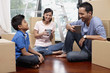 © ImageHit - Family taking a break in new house