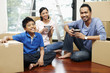 © ImageHit - Family taking a break in new house