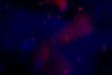 Wall Mural - red bokeh patterned on a dark blue background