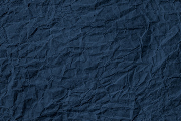 Wall Mural - crumpled dark blue paper textured background